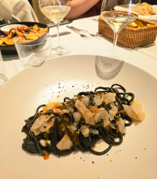 Chitarra nera: Creamy black pasta with shellfish and shrimp tartare.